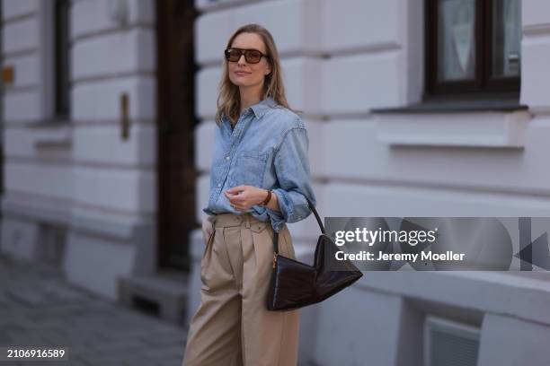 Marlies Pia Pfeifhofer seen wearing Vehla Eyewear brown sunglasses, Citizen of Humanity light blue denim blouse / buttoned shirt, Andiata beige wide...