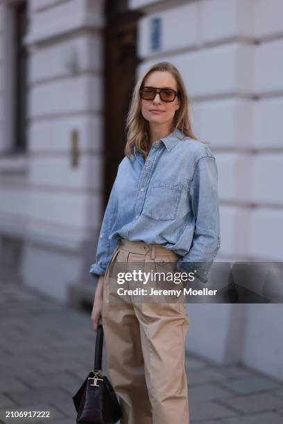 Marlies Pia Pfeifhofer seen wearing Vehla Eyewear brown sunglasses, Citizen of Humanity light blue denim blouse / buttoned shirt, Andiata beige wide...