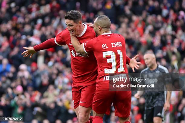 Fernando Torres of Liverpool Legends celebrates scoring his team's fourth goal with Nabil El Zhar during the LFC Foundation charity match between...