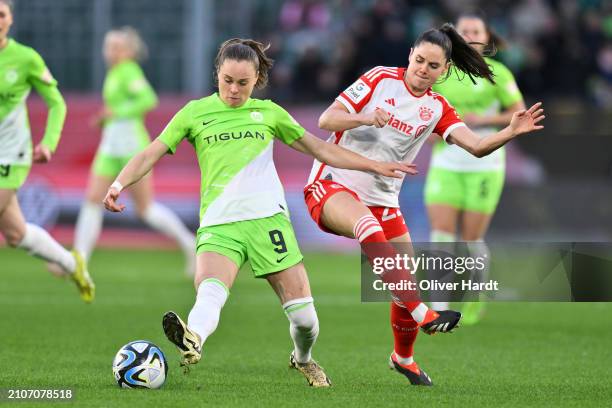 Ewa Pajor of VfL Wolfsburg competes for the ball with Sarah Zadrazil of FC Bayern München during the Google Pixel Women's Bundesliga match between...