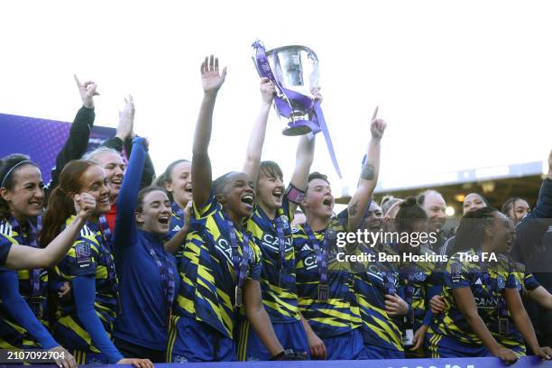 Grace Gillard of Hashtag United lifts the FA Women's National League Cup trophy after their team's victory in the FA Women's National League Cup...