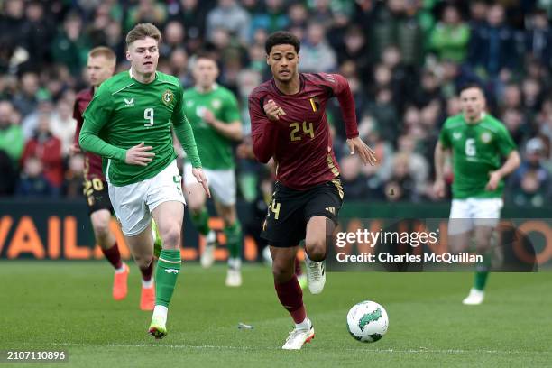 Koni De Winter of Belgium runs with the ball whilst under pressure from Evan Ferguson of Republic of Ireland during the international friendly match...