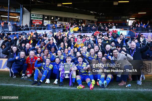 Players and staff of Hashtag United pose for a photo with the FA Women's National League Cup trophy after the team's victory in the FA Women's...