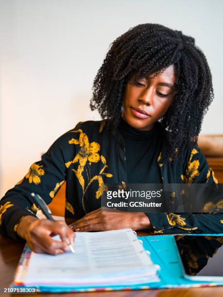 completing paperwork while working remotely from home. - deadline contenders stock pictures, royalty-free photos & images