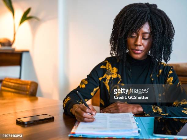 completing paperwork while working remotely from home. - deadline contenders stock pictures, royalty-free photos & images
