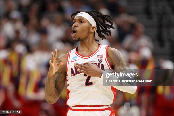 Caleb Love of the Arizona Wildcats celebrates a three point basket against the Dayton Flyers during the first half in the second round of the NCAA...