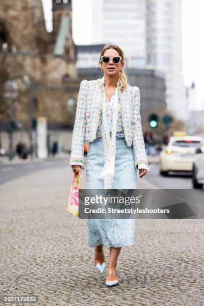 Tamara von Nayhauss, wearing a multicolored Boucle jacket by Maison commen, a white silk blouse with multicolored heards by Maison Common, a light...