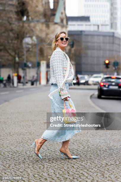 Tamara von Nayhauss, wearing a multicolored Boucle jacket by Maison commen, a white silk blouse with multicolored heards by Maison Common, a light...