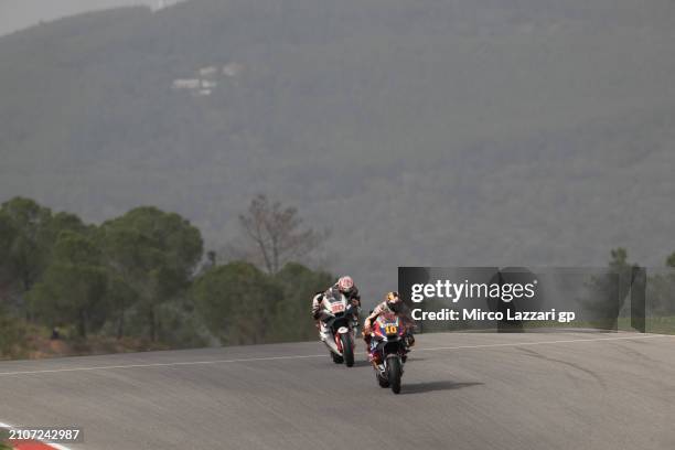 Luca Marini of Italy and Repsol Honda Team leads Takaaki Nakagami of Japan and IDEMITSU Honda LCR during the MotoGP Of Portugal - Sprint at Autodromo...