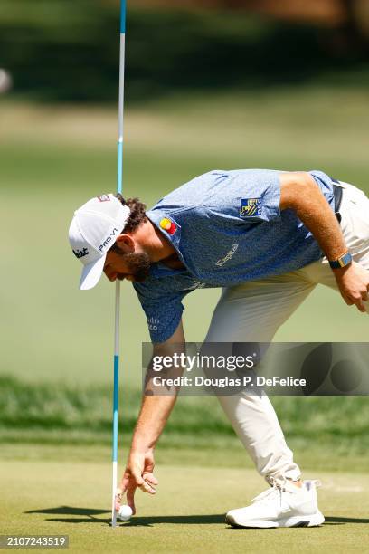 Cameron Young of the United States picks up his ball after an eagle on the seventh green during the third round of the Valspar Championship at...