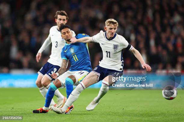 Anthony Gordon of England is challenged by Raphinha of Brazil during the international friendly match between England and Brazil at Wembley Stadium...