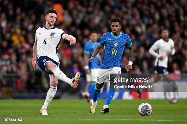 Declan Rice of England passes the ball whilst under pressure from Rodrygo of Brazil during the international friendly match between England and...