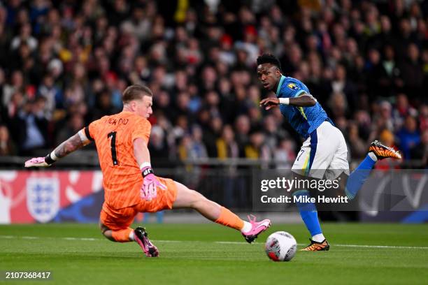 Vinicius Junior of Brazil takes a shot past Jordan Pickford of England which is later cleared off the line by Kyle Walker of England during the...