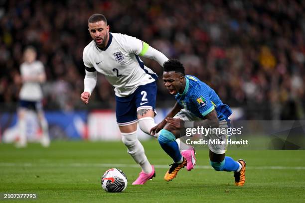 Vinicius Junior of Brazil goes down after a challenge from Kyle Walker of England during the international friendly match between England and Brazil...