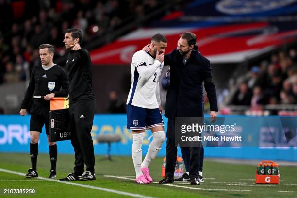 Kyle Walker of England speaks with Gareth Southgate, Manager of England, after leaving the pitch after picking up an injury during the international...