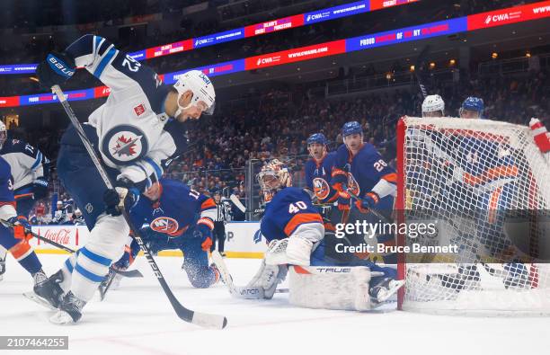 Semyon Varlamov and the New York Islanders defend against Nino Niederreiter of the Winnipeg Jets during the second period at UBS Arena on March 23,...