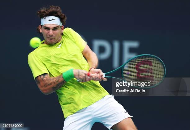 Thiago Seyboth Wild of Brazil returns a shot against Taylor Fritz during their match on day 8 of the Miami Open at Hard Rock Stadium on March 23,...