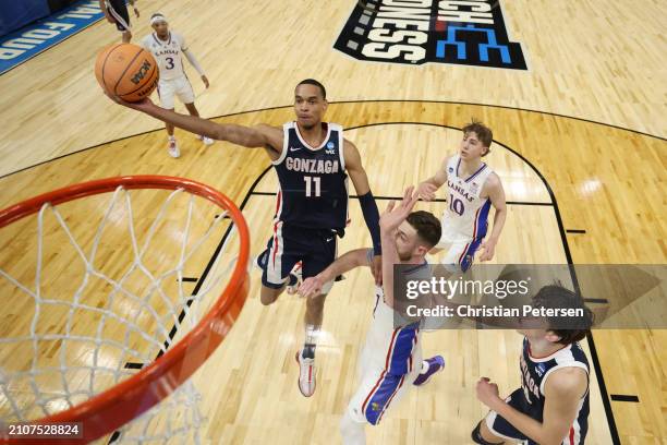 Nolan Hickman of the Gonzaga Bulldogs drives to the basket against Hunter Dickinson of the Kansas Jayhawks during the first half in the second round...