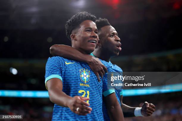 Endrick of Brazil celebrates scoring his team's first goal with teammate Vinicius Junior during the international friendly match between England and...