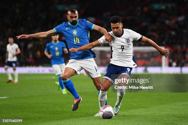 Ollie Watkins of England is challenged by Fabricio Bruno of Brazil during the international friendly match between England and Brazil at Wembley...