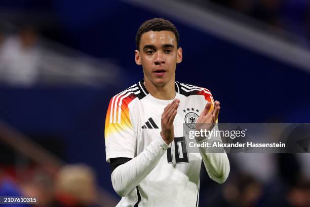 Jamal Musiala of Germany applauds the fans during the international friendly match between France and Germany at Groupama Stadium on March 23, 2024...