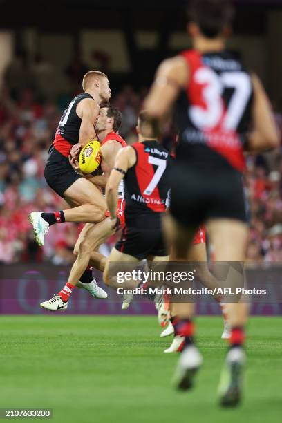 Harry Cunningham of the Swans is challenged by Peter Wright of the Bombers during the round two AFL match between Sydney Swans and Essendon Bombers...