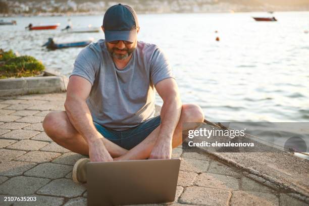 mature adult man traveler ( with laptop) - one embankment stock pictures, royalty-free photos & images
