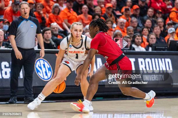 Guard Kennedie Shuler of the Oregon State Beavers attempts to dribble the ball around point guard Alexis Pettis of the Eastern Washington Eagles...