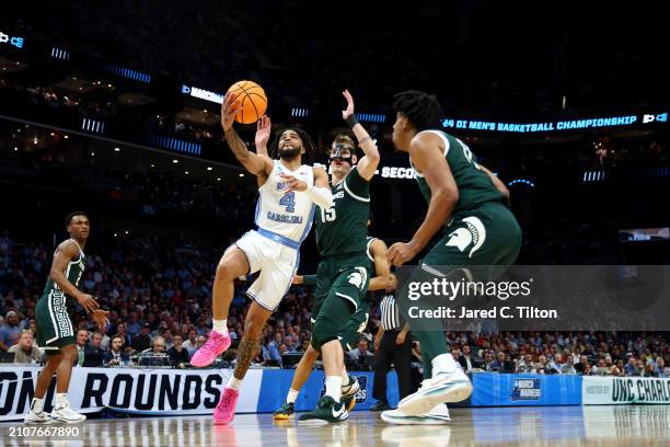 Davis of the North Carolina Tar Heels drives to the basket against Carson Cooper of the Michigan State Spartans in the first half in the second round...