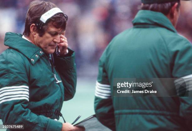 Philadelphia Eagles head coach Dick Vermeil looks over his playbook during a regular season game against the New York Giants on November 22, 1981 at...