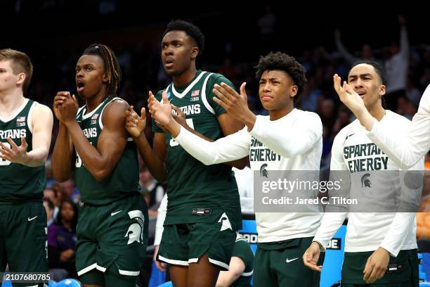 The Michigan State Spartans react on the bench during the first half against the North Carolina Tar Heels in the second round of the NCAA Men's...
