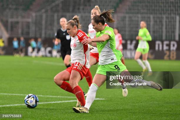 Ewa Pajor of VfL Wolfsburg competes for the ball with Georgia Stanway of FC Bayern München during the Google Pixel Women's Bundesliga match between...