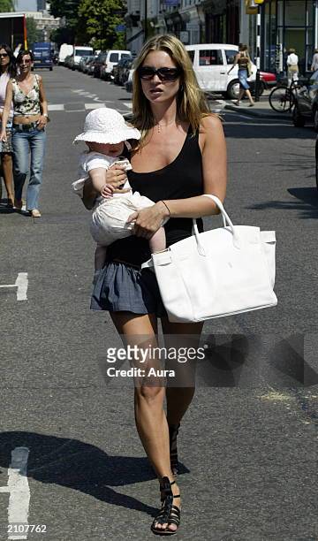 Model Kate Moss walks with her baby daughter Lola in Notting Hill June 24, 2003 in West London.