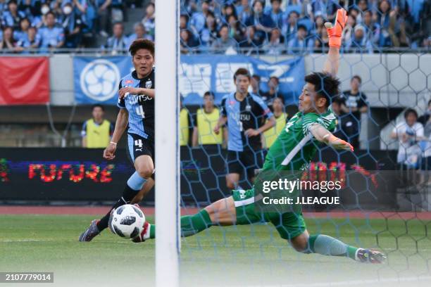 Yoshito Okubo of Kawasaki Frontale scores the team's fourth goal past Kwoun Sun-tae of Kashima Antlers during the J.League J1 match between Kawasaki...