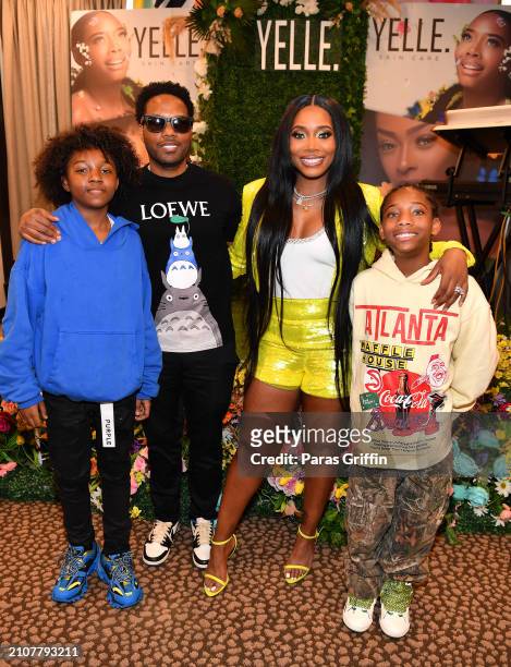 Mendeecees Harris and Yandy Smith pose with family members during the Yelle Skin Care meet & greet at Bloomingdale's Lenox Square on March 23, 2024...