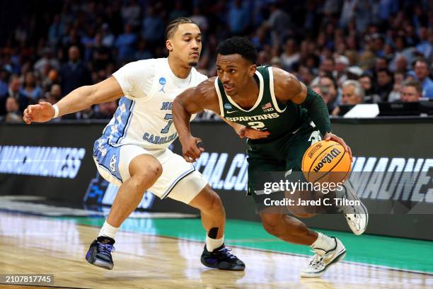 Tyson Walker of the Michigan State Spartans drives past Seth Trimble of the North Carolina Tar Heels during the second half in the second round of...