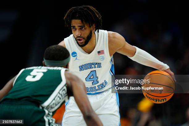 Davis of the North Carolina Tar Heels handles the ball against Tre Holloman of the Michigan State Spartans during the second half in the second round...