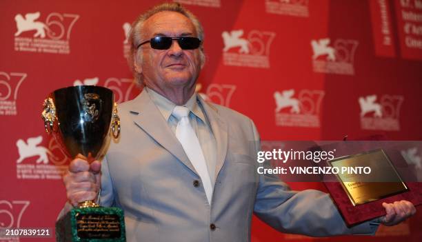 Polish film director Jerzy Skolimowski poses with the Special Prize of the jury he received for his film "Essential killing" and with the Volpi Cup...