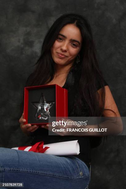 French actress Hafsia Herzi poses after receiving an award for her performance in the movie "La graine et le mulet" directed by Abdellatif Kechiche,...