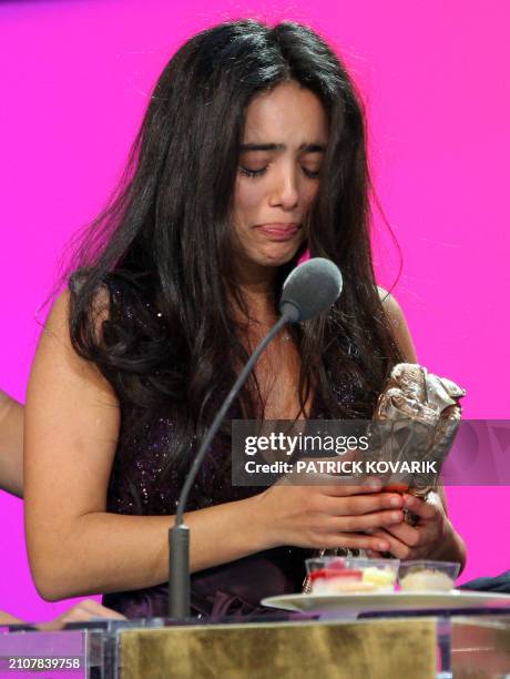 Tunisian actress Hafsia Herzi reacts after she received the Best newcomer actress award during the 33rd Nuit des Cesar, France's top movie awards, on...