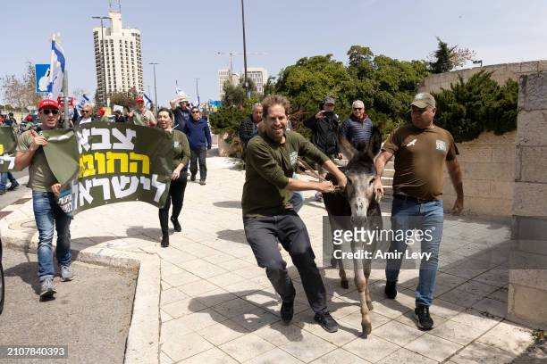 Protesters bring donkeys to a demonstration calling for equality in military service near the official Prime Minister office on March 26, 2024 in...