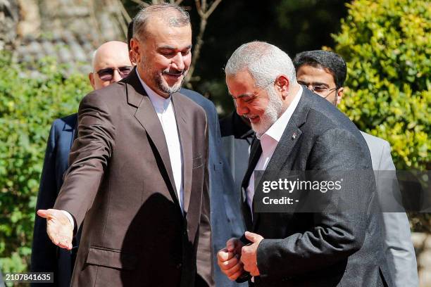 Iran's Foreign Minister Hossein Amir-Abdollahian receives Hamas' Doha-based political bureau chief Ismail Haniyeh at the foreign ministry...