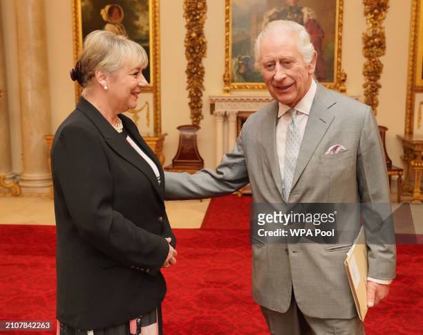 King Charles III greets Dame Martina Milburn prior to an audience with community faith leaders from across the UK who have taken part in a Windsor...