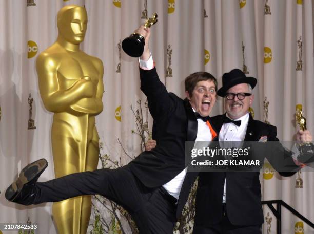 Winners for Best Short Film "The fantastic Flying Books of Mr. Morris Lessmore," William Joyce and Brandon Oldenburg pose with their trophies in the...
