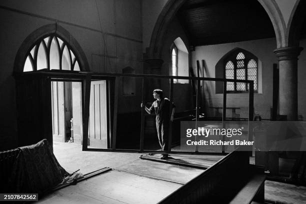 Workmen remove fixtures and furniture from St Luke church on Bridge Street, in Newport, Wales, on 3rd June 1985.