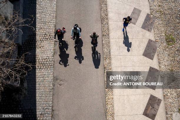 Top view of cyclists and joggers on the cycle path and pedestrian walkway on the Quai du Rh?ne in Lyon, France on 19 March 2024.