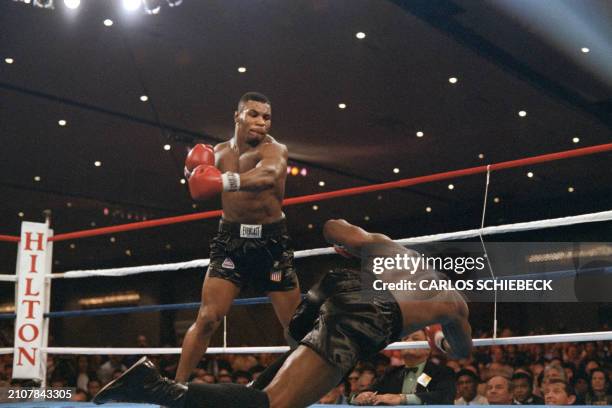 Heavyweight champion Trevor Berbick goes down after a hard left from challenger Mike Tyson in the 2nd round of their scheduled 12 round WBC title...