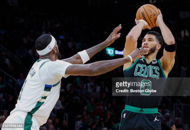 Boston, MA Boston Celtics forward Jayson Tatum shoots over Milwaukee Bucks forward Bobby Portis in the first quarter. The Celtics beat the Bucks,...
