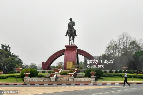 Traffic police officer walks past the statue of General Aung San in Naypyidaw on March 26, 2024. Myanmar's junta prepared to put on a show of force...