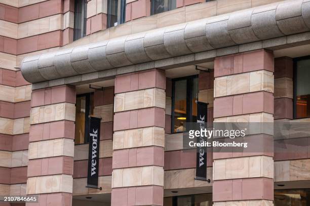 Banners outside WeWork offices in the City of London, UK, on Tuesday, March 26, 2024. Adam Neumann and several partners submitted an offer to...